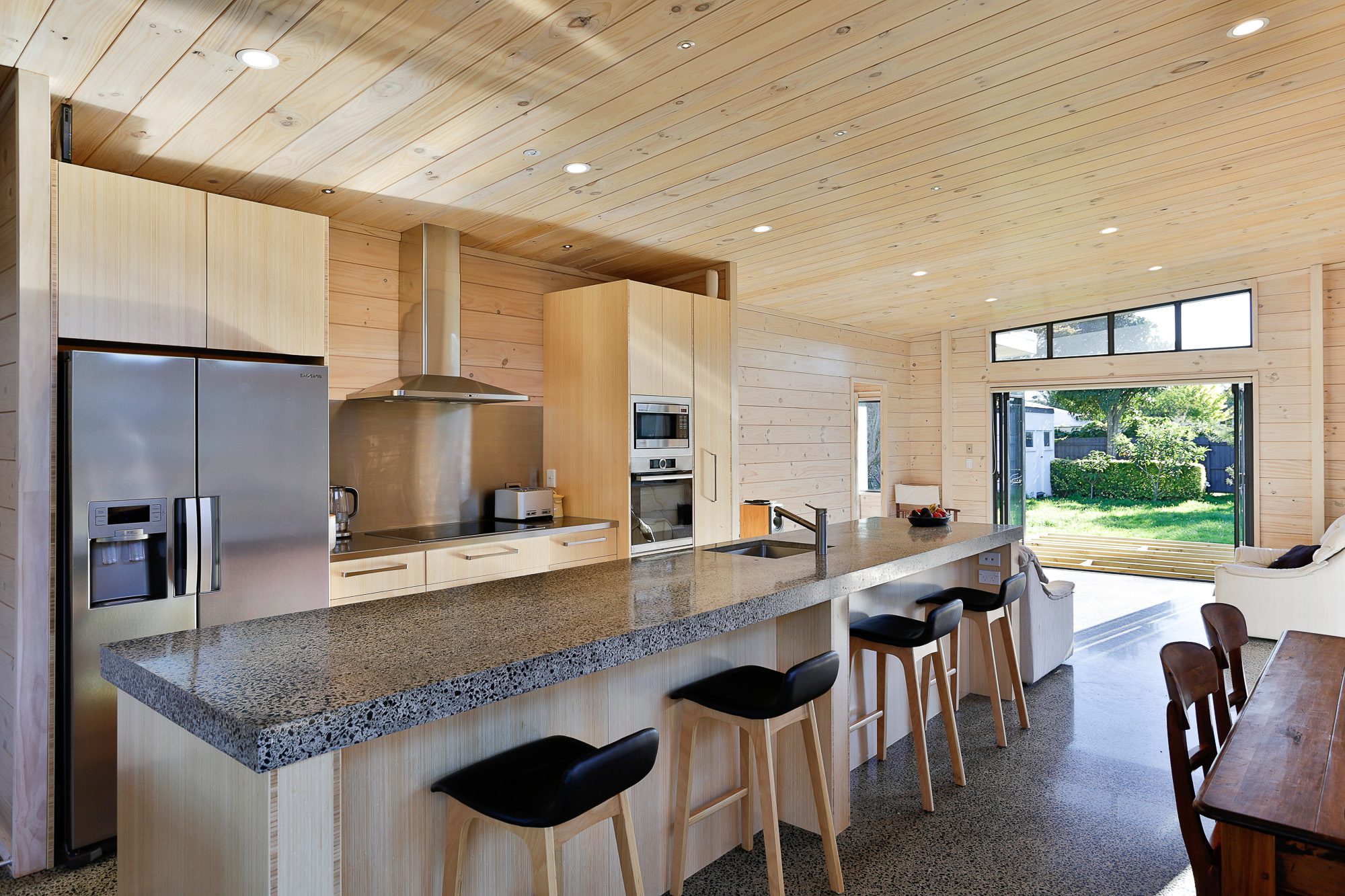Stainless steel splashback with polished concrete counter tops