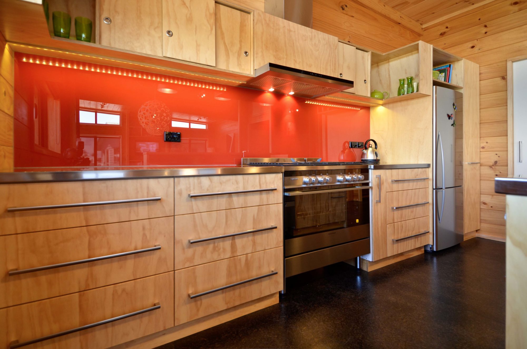 Tangerine orange splashback in timber kitchen