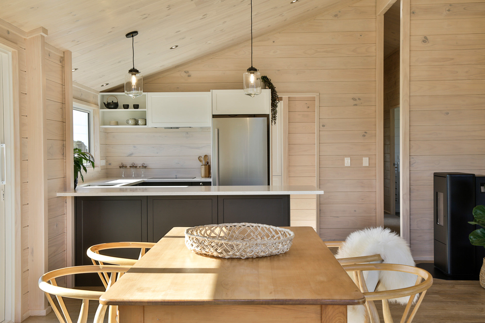 Dark kitchen cabinets contrast against blonded Lockwood interior