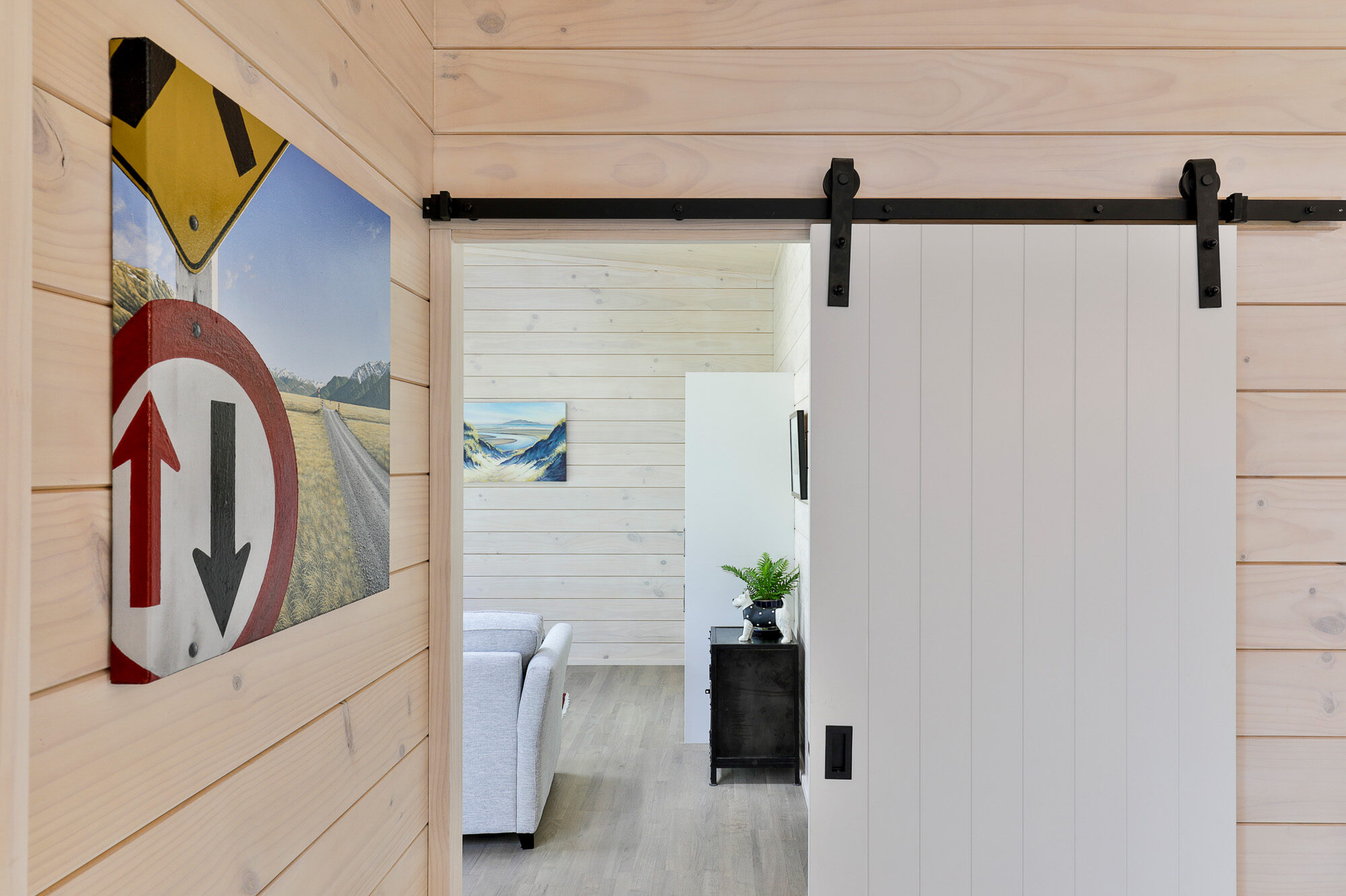 White barn door helps continue modern natural feel to home